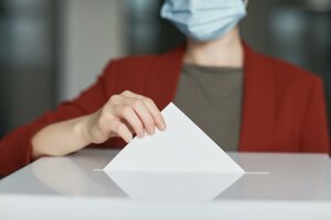 Ballot Box with Person Casting a Vote